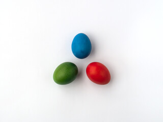 Three Easter egss in RGB colors - red, green, blue, standing on a white background, making a symbol for primary colors