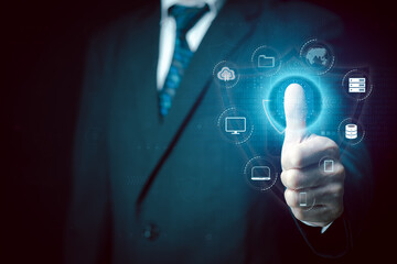 Businessman scans his fingerprint to unlock all Information technology devices. Futuristic business technology security concept. Innovation technology against digital cybercrime. Biometrics identity.