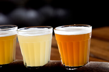 Different color wheat beer varieties in small glasses for sampling