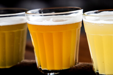 Different color wheat beer varieties in small glasses for sampling