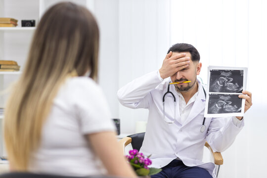 Photo of pregnant woman speaking with a doctor.