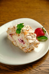 Obraz na płótnie Canvas Cake with meringue roll with cream and raspberries