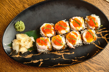 A set of sushi rolls with salmon, caviar, avocado and black sesame in close-up