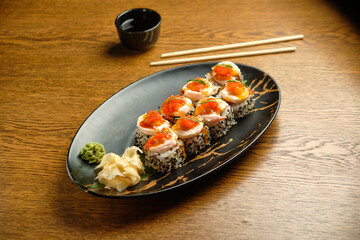 A set of sushi rolls with salmon, caviar, avocado and black sesame in close-up