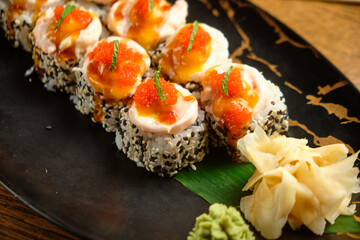 A set of sushi rolls with salmon, caviar, avocado and black sesame in close-up