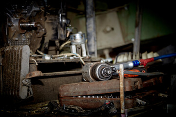 Fototapeta na wymiar A professional mechanic works on a car engine in a garage. Car service.