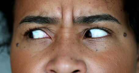 Anxious black woman macro close-up eyes looking side to side
