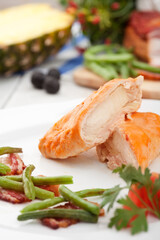 Chicken meat, vegetables in a plate. Photo of food on a white background