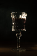 old crystal glass with red drink
