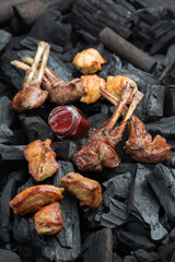 Grilled ribs, charcoal background. Photo of food on a dark background