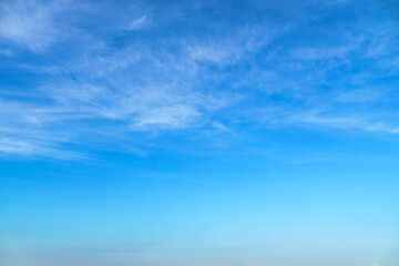 bright blue sky with clouds as abstract background