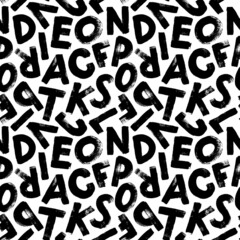 Vector seamless pattern with grunge letters of the alphabet in random order on a white background. Hand drawn grunge ink illustration. Handwritten latin letters. Black textured brush strokes. © Anastasiia Hevko