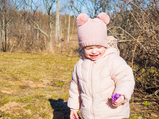 portrait of a little girl with flowers in a spring square