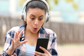 Amazed teen listening to music finding phone content