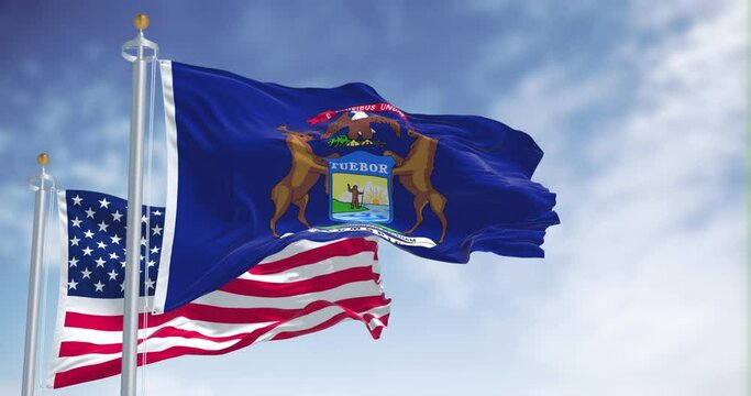 The Michigan state flag waving along with the national flag of the United States of America
