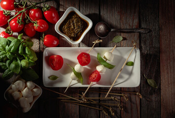 Naklejka na ściany i meble Mozzarella with basil, pesto, and tomatoes.