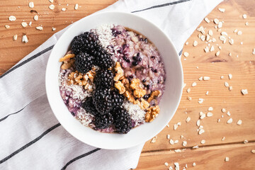 Oatmeal bowl with blackberries, hazelnut, coconut, healthy, put ina bowl, breakfast meal
