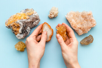 Hands holding natural mineral rock or shiny gemstone