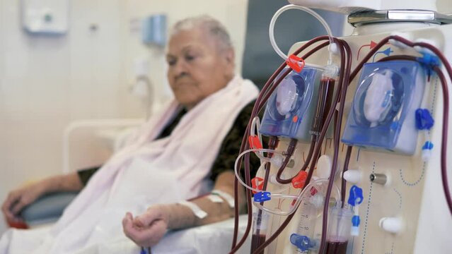 Hardware Hemodialysis. An elderly person, a patient connected to a blood assessment machine.