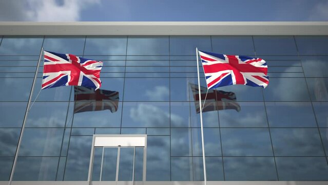 Waving flags of the United Kingdom UK in the airport and landing airplane