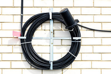 an optical coupling hangs on the wall, an optical cable is brought into it from different sides