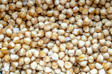 Boiled chickpeas, high protein food. Vegan food, background from boiled chickpeas. Top view, selective focus.