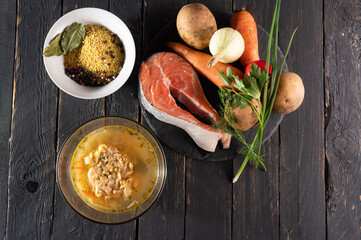 Red fish soup. Vegetables, spices and red fish. Salmon soup. A dish of fish on the table. Top view.
