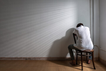 Male depression. Upset Asian young man got problem sitting alone at home, a lot of thoughts, break up with a lover or financial difficulties and debt Overthinking Unhappy unsatisfied and trouble idea