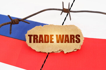 On the flags of Poland and Russia lies a cardboard plate with the inscription - Trade wars
