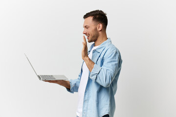 Friendly cheerful handsome man in casual basic t-shirt greeting waving at laptop doing video call posing isolated on white studio background. Copy space Banner Mockup. Distance communication concept