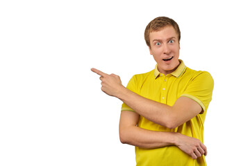 Surprised guy with funny face in yellow T-shirt pointing finger to left, white background