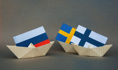 ships with Finnish, Sweden, and Russian flags concept of border conflict, independence and freedom...