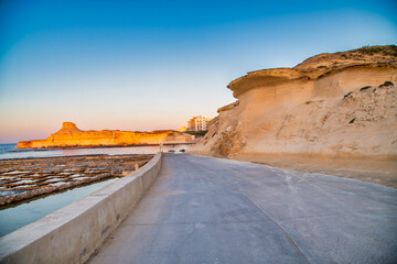 Salt pans in Zebbug, Gozo, road at sunset