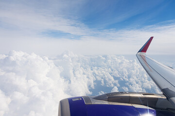 Swirling cumulus clouds in the turbulence area view of the aircraft wing and engine.