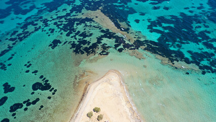 Aerial drone photo of tropical exotic paradise island bay with deep turquoise sea forming a blue lagoon visited by luxury yachts and sail boats