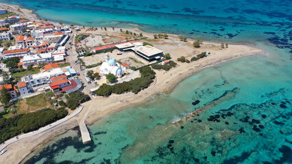 Aerial drone photo of iconic picturesque village, main port and beautiful turquoise beaches of...