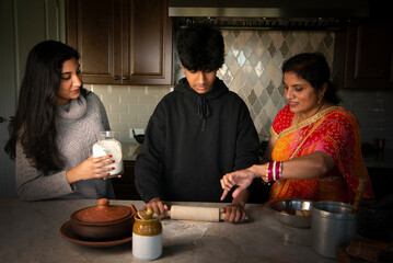 Mother teaching son how to make roti - breaking gender roles 