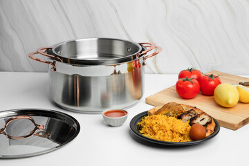 Stainless steel kitchen cookware on non isolated background