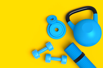 Top view of sport equipment like kettlebell, dumbbell and yoga mat on yellow