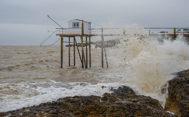 Fototapeta na wymiar Stormy seas and ocean waves on rocky Atlantic coast at Charente-Maritime, France near La Rochelle