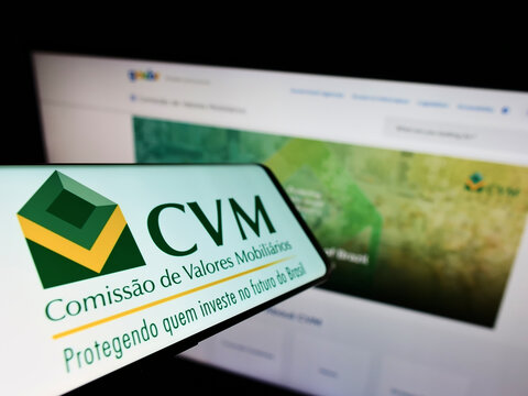 Stuttgart, Germany - 03-30-2022: Mobile phone with logo of Brazilian Comissao de Valores Mobiliarios (CVM) on screen in front of website. Focus on center-left of phone display.