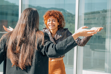 girls in the street greeting each other happily