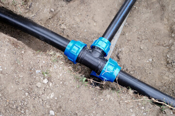 Equipment for automatic watering soil pipes lying in ground closeup