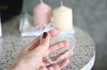 closeup hand with manicure holding heart candles table love woman fingers