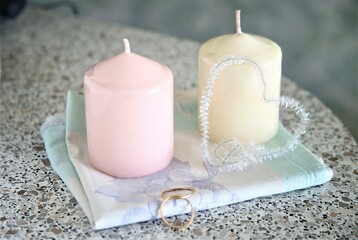 Closeup candles and wedding rings on the table flame light decorate marry heart love