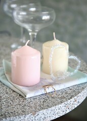 closeup candle and wedding rings on a table celebration marriage glasses holiday