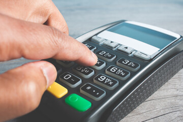 Closed hand socket by entering code in payment terminal. concept purchases with cards