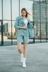 Girl walking down the street in summer clothes. Summer clothes collection.