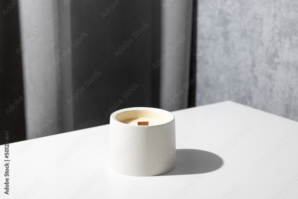 Wall mural candle soy homemade in ceramic burning in grey modern interior room, atmosphere and minimalistic com