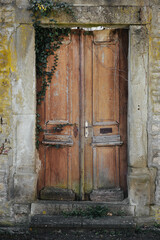 Old vintage wooden door in a stone wall